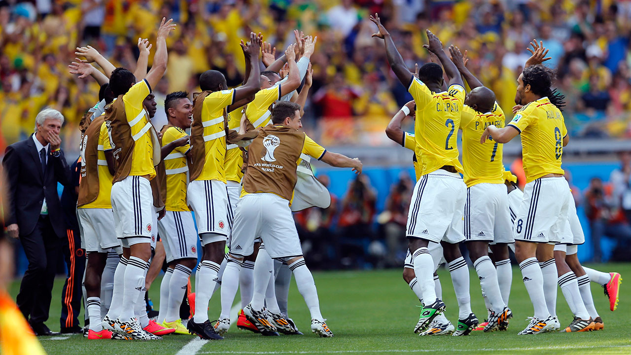 Colombian players celebrate after Pablo Armero scored the opening goal during their Group C World Cup match against Greece in Belo Horizonte, Saturday, June 14, 2014.